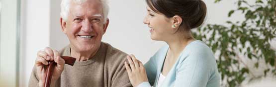 Elderly man interacting with caretaker