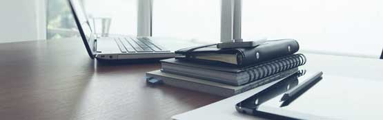 Desk with laptop, books and supplies