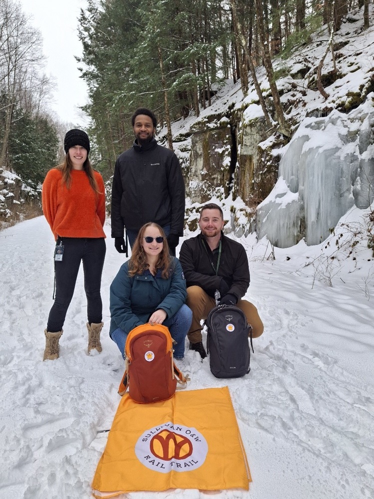 a group of people posing for a picture in the snow